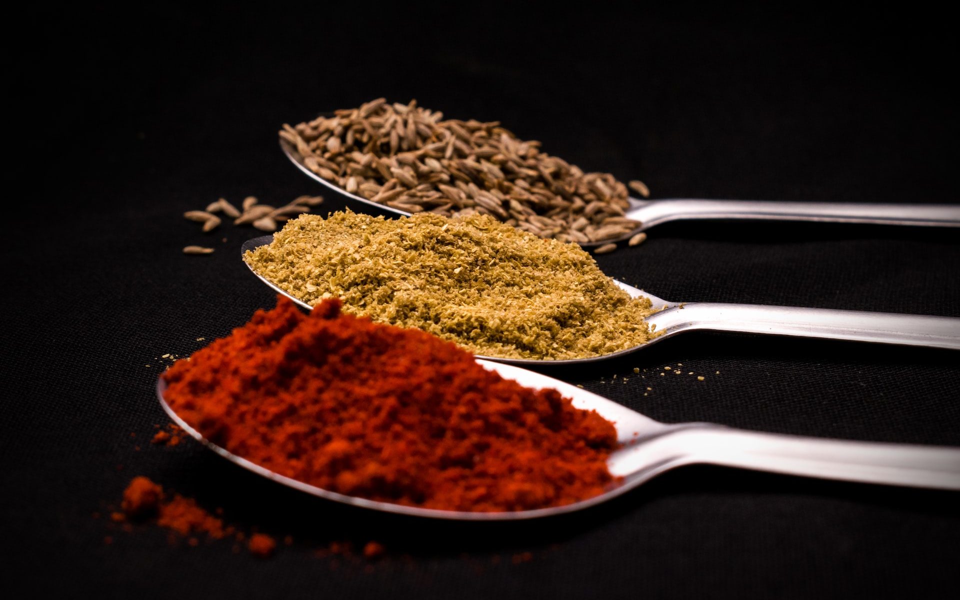 different spices on a spoon